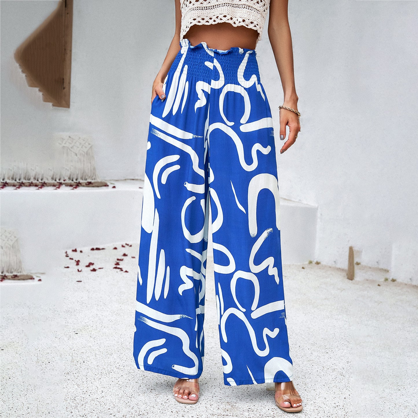 Woman modeling blue wide-leg abstract print pants and crochet crop top, FashionRay style