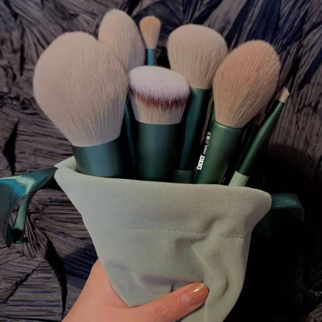 Set of makeup brushes in a soft pouch, held by hand, FashionRay beauty tools