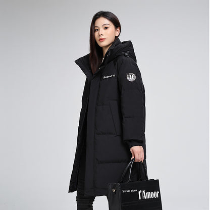 Woman wearing a black puffer coat and holding a trendy black tote bag from FashionRay