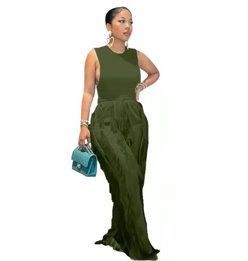 Woman wearing olive green sleeveless top and wide-leg pants, holding teal purse, FashionRay style
