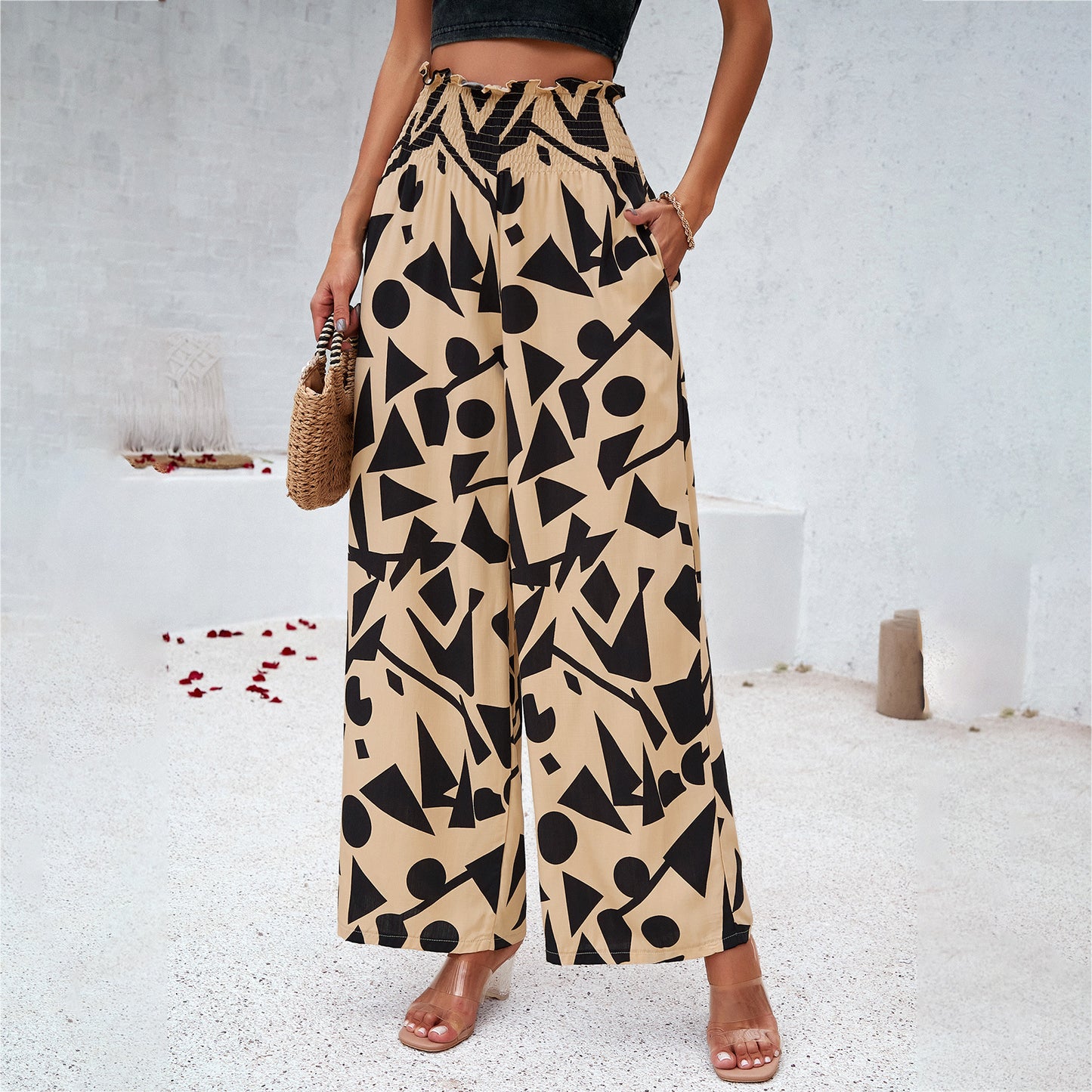 Woman in wide-leg beige pants with bold black geometric pattern, summer fashion, FashionRay