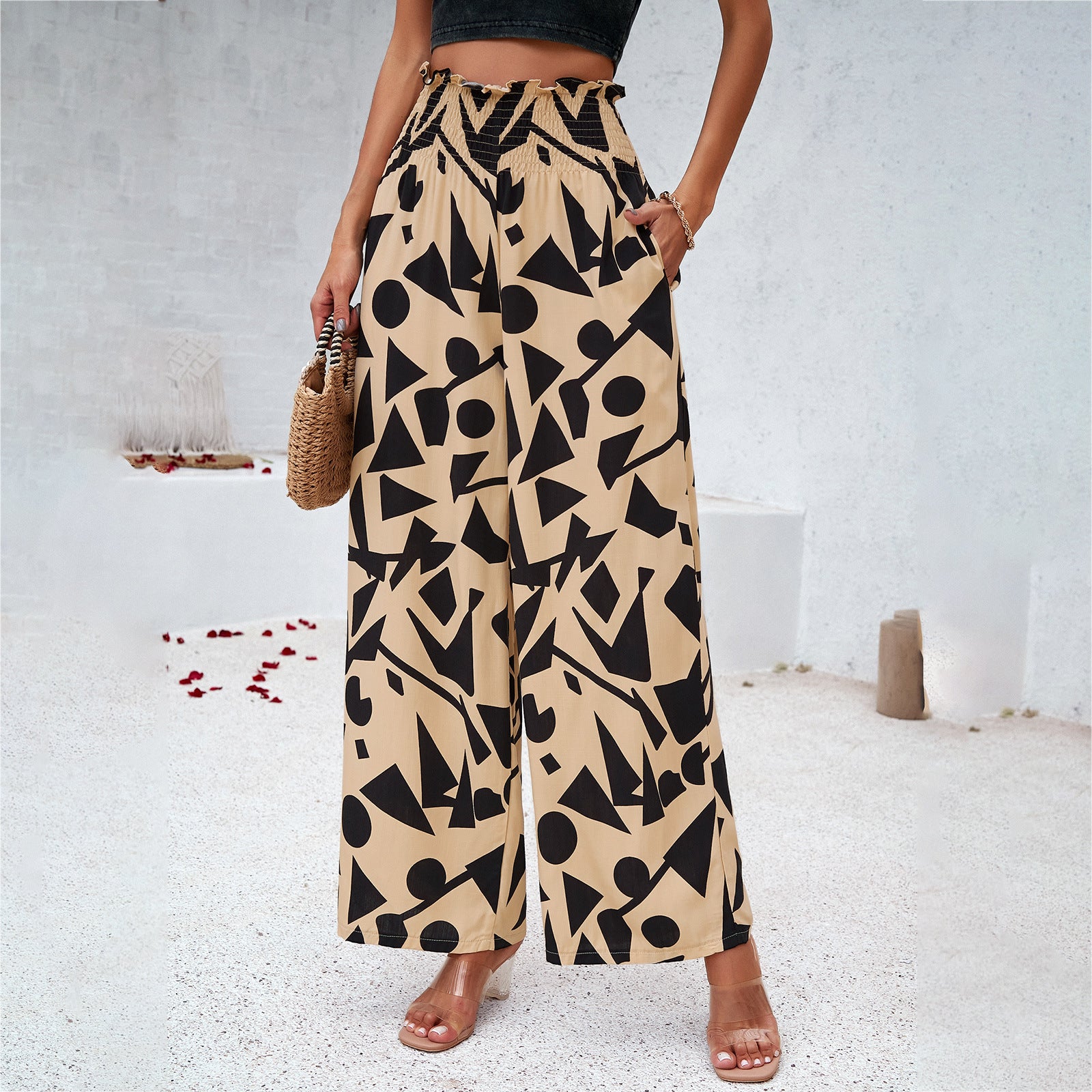 Woman in wide-leg beige pants with bold black geometric pattern, summer fashion, FashionRay