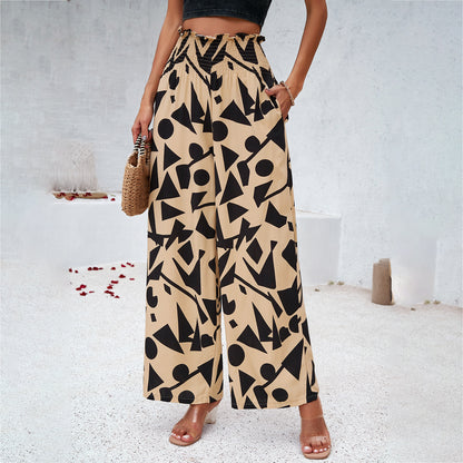 Woman in wide-leg beige pants with bold black geometric pattern, summer fashion, FashionRay