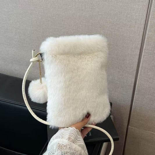 White faux fur crossbody bag with pom-pom, trendy accessory at FashionRay