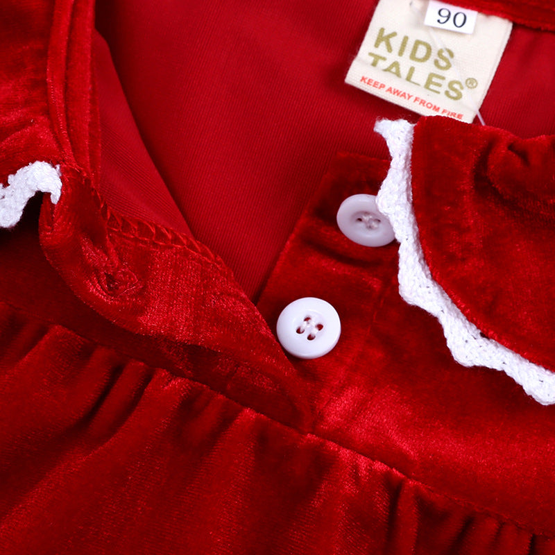 Close-up of red velvet kids dress with white buttons and lace collar at FashionRay