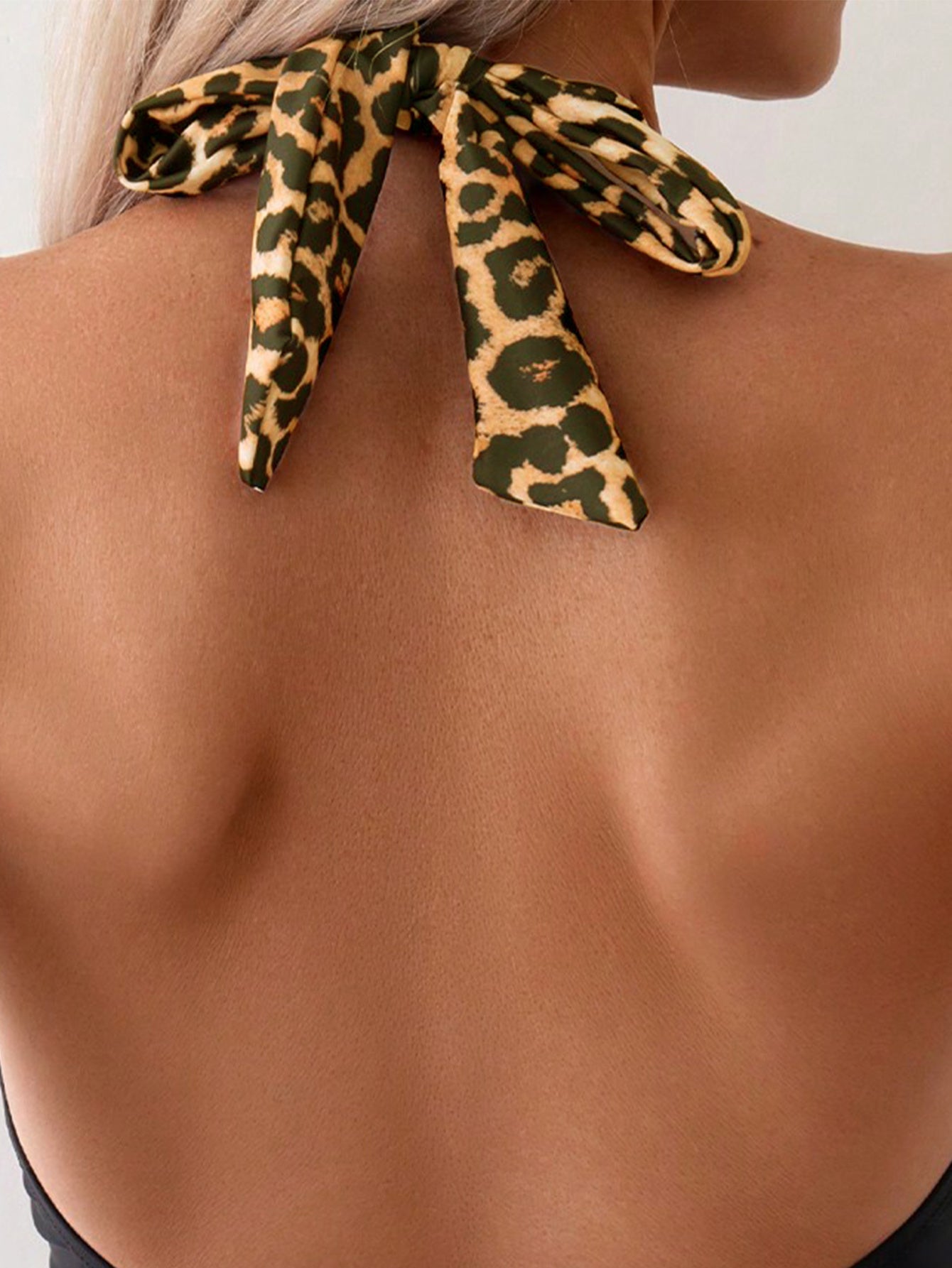Close-up of backless top with leopard print tie, FashionRay trendy bold style