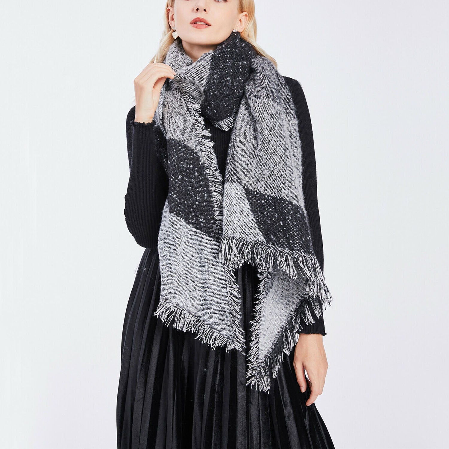 Woman wearing a black and grey plaid fringed scarf and black dress, FashionRay style
