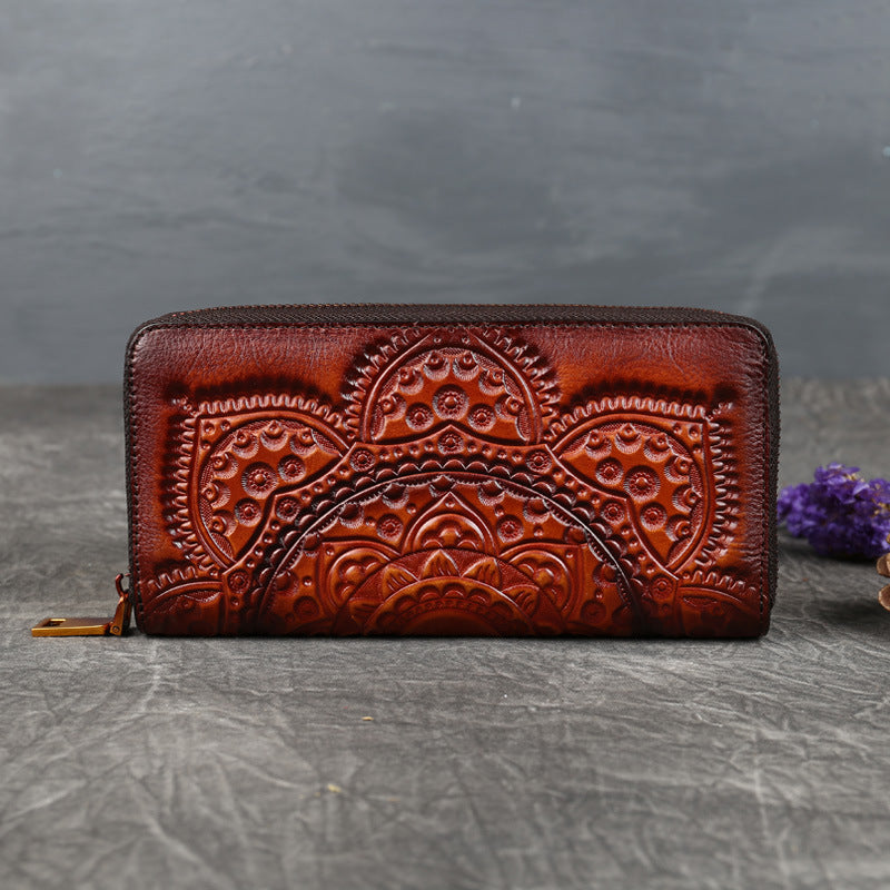 Brown embossed leather wallet with floral mandala design on stone background, FashionRay