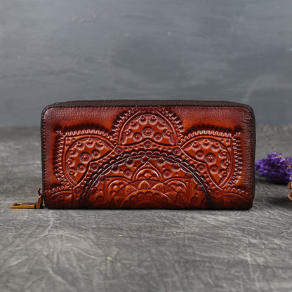 Brown embossed leather wallet with floral mandala design on stone background, FashionRay