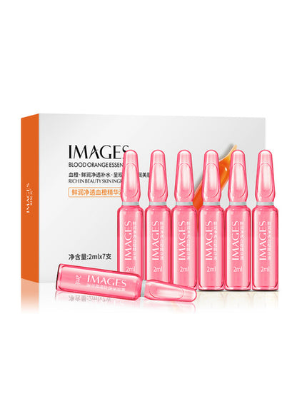 Blood orange essence skincare ampoules by IMAGES, pink glass vials in front of branded box