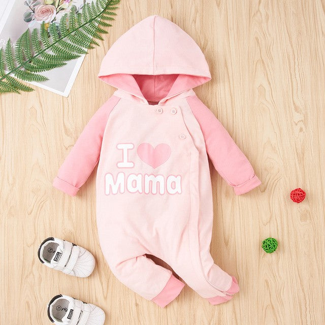 Pink baby hooded romper with 'I love Mama' text from FashionRay, styled on a wooden floor