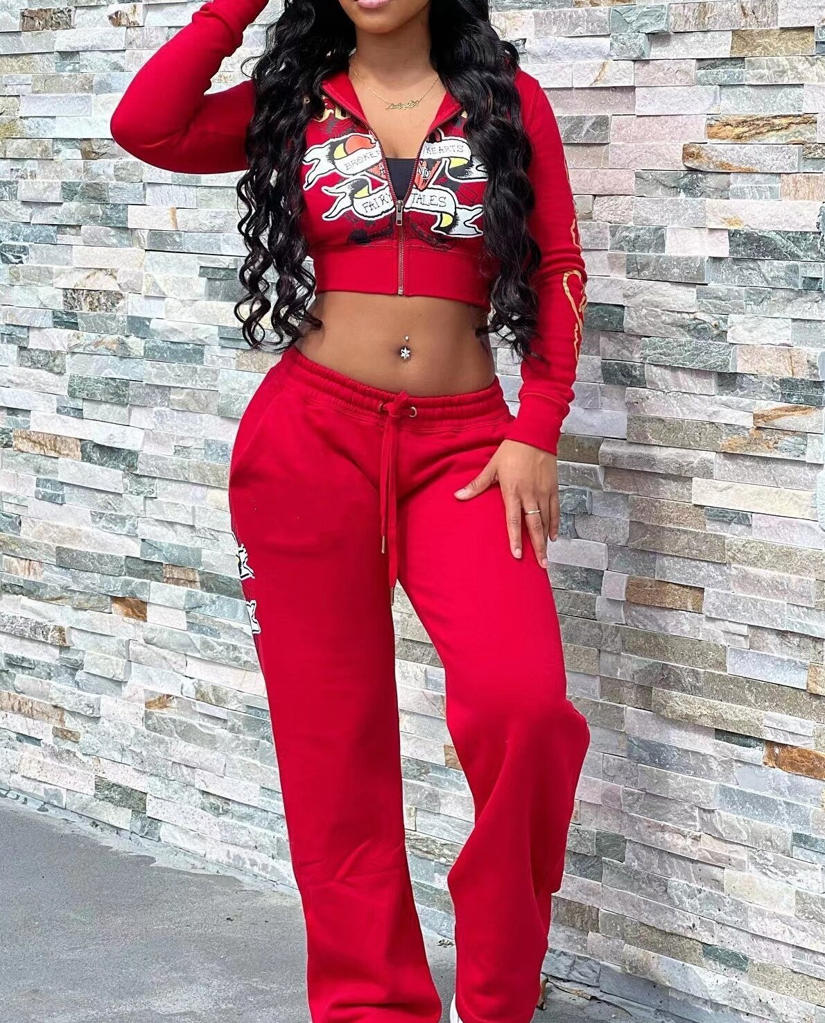 Woman in red graphic crop hoodie and matching sweatpants, casual fashion set, FashionRay