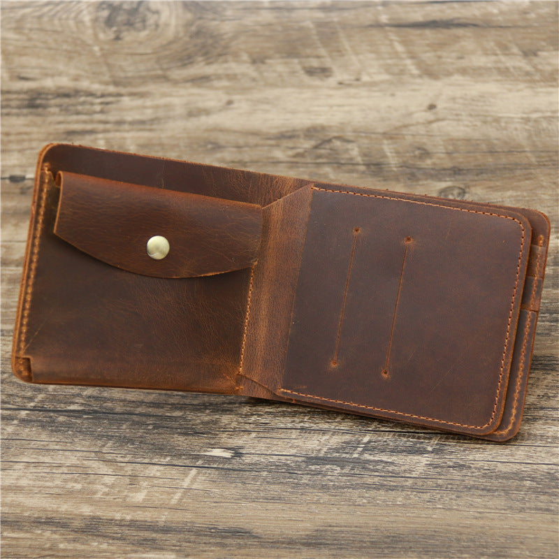 Open brown leather wallet with snap coin pocket on rustic wooden surface, FashionRay accessory