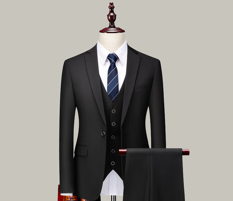 Classic black three-piece men's suit with tie displayed on mannequin, FashionRay style