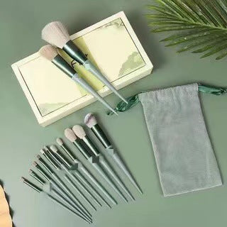 FashionRay makeup brush set with green handles, storage pouch, and decorative box on green background.