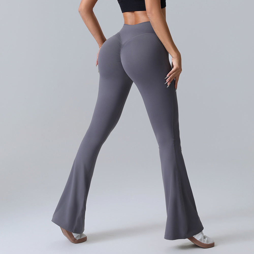 Woman in high-waisted grey flare leggings and black crop top, FashionRay trendy activewear