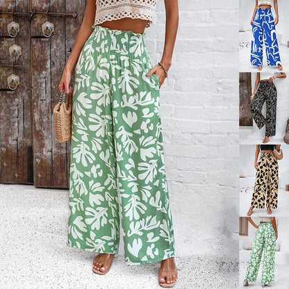 Woman wearing wide-leg leaf print pants in green and white, FashionRay trendy summer style