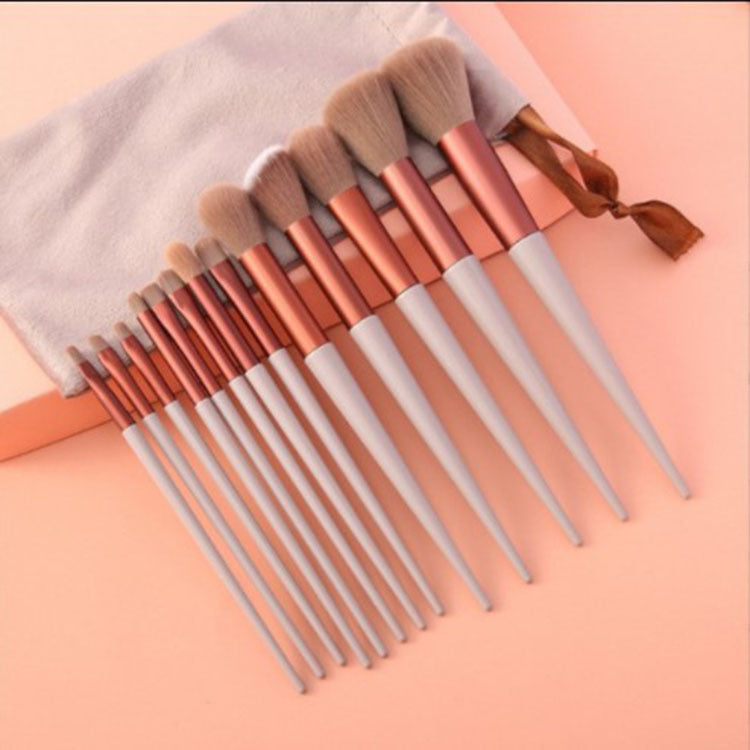 FashionRay makeup brush set with rose gold and white handles on peach background