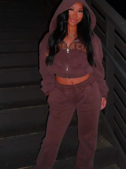 Woman in brown hoodie and sweatpants on stairs, trendy FashionRay loungewear style