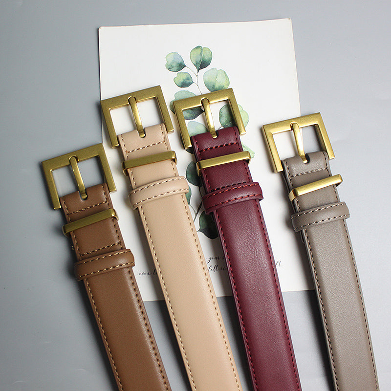 Four stylish FashionRay leather belts in brown, beige, burgundy, and gray with gold buckles