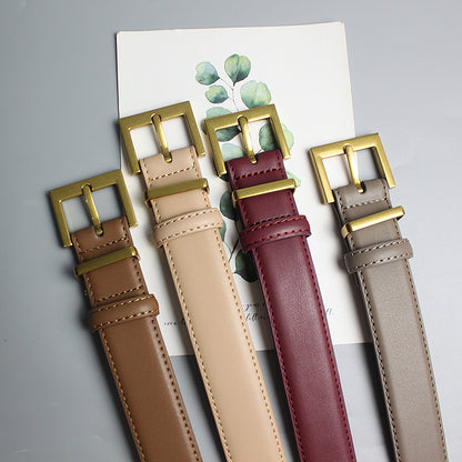Four stylish FashionRay leather belts in brown, beige, burgundy, and gray with gold buckles