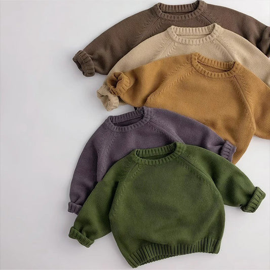 Five cozy knit sweaters in earth tones, folded, showcasing trendy FashionRay comfort style.