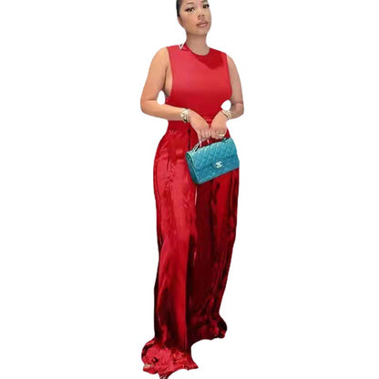 Woman in sleeveless red jumpsuit holding a blue quilted purse, FashionRay style