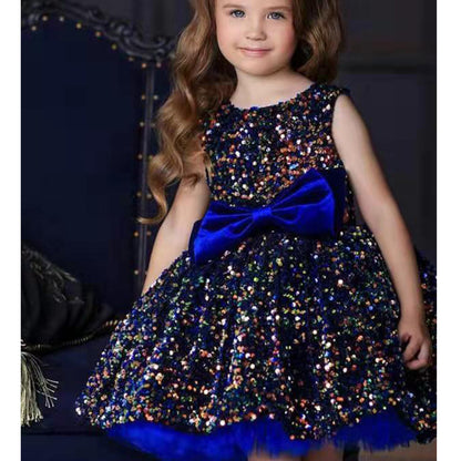 Girl in sparkly blue sequin dress with large blue bow, FashionRay party fashion