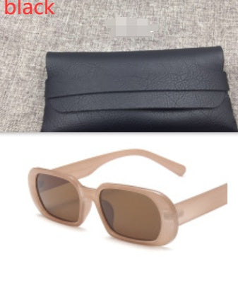 FashionRay black faux leather clutch on gray fabric and beige retro sunglasses with brown lenses