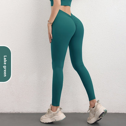 Woman wearing lake green high-waist leggings and sneakers, FashionRay activewear style
