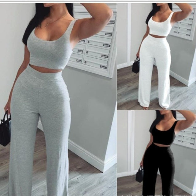 Woman modeling trendy two-piece lounge set in grey, white, and black from FashionRay