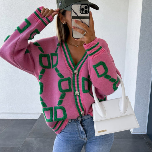 Woman in a pink and green geometric cardigan, blue jeans, white handbag, and cap, FashionRay style