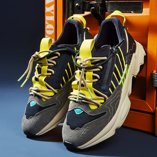 Trendy multicolor sneakers with yellow, navy, and grey details, showcased on a blue background for FashionRay.