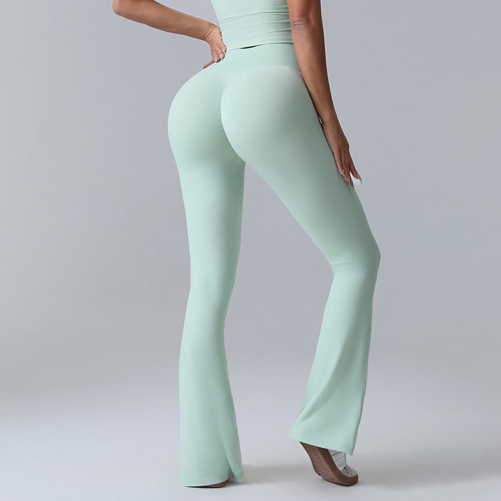 Woman modeling mint green high-waisted flared leggings from FashionRay