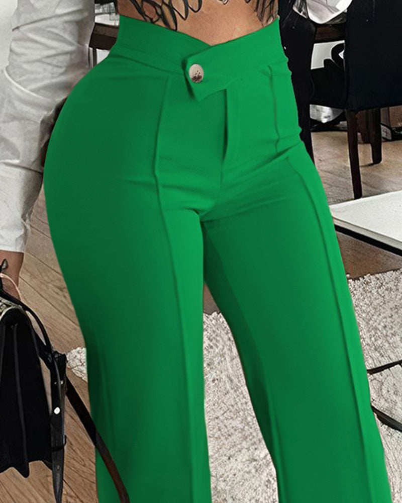 Woman wearing high-waisted green trousers from FashionRay, standing in a stylish indoor setting