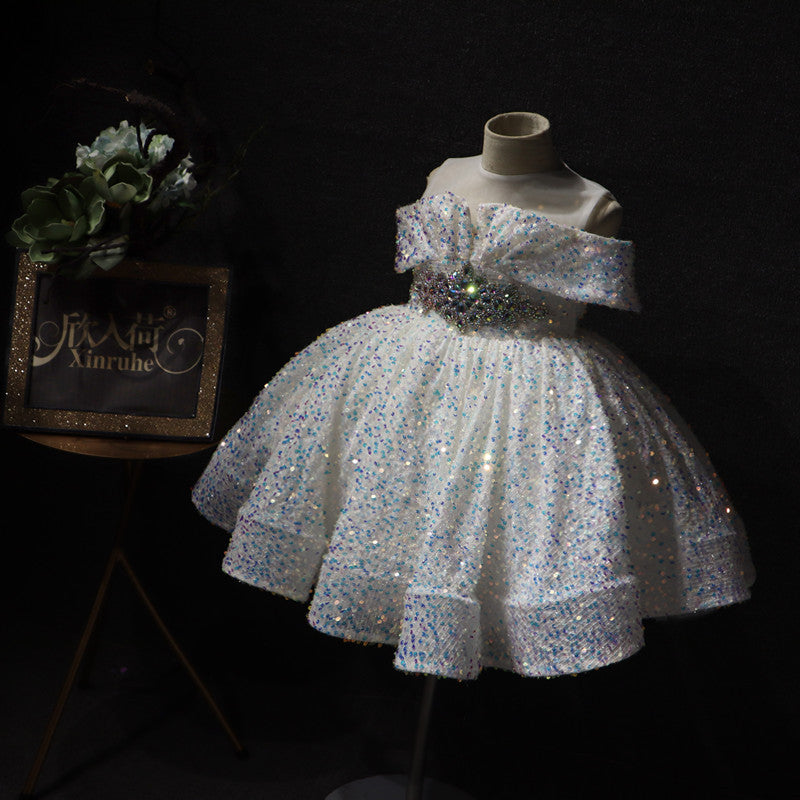 Sparkly white off-shoulder girl's dress on mannequin with floral decor, FashionRay style