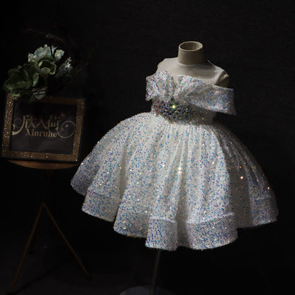 Sparkly white off-shoulder girl's dress on mannequin with floral decor, FashionRay style