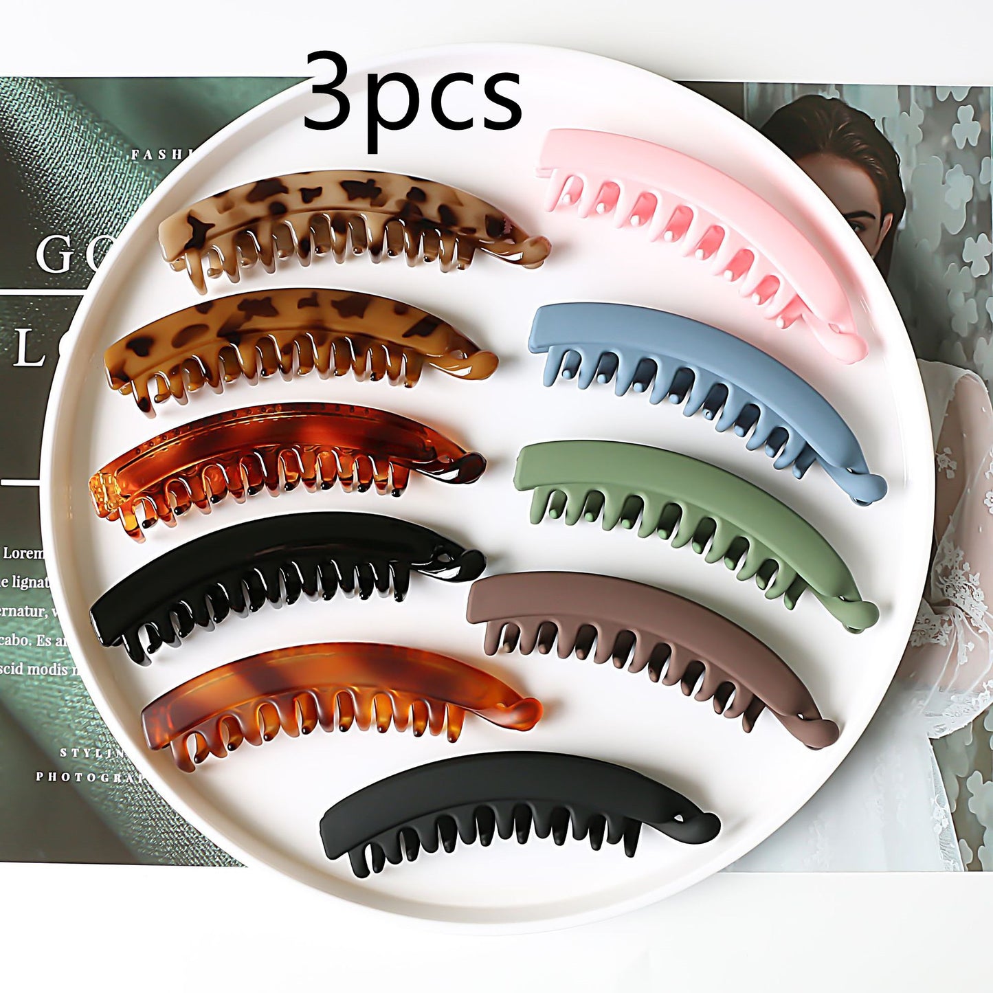 Assorted large hair claws in various colors and patterns on a white tray, FashionRay accessories