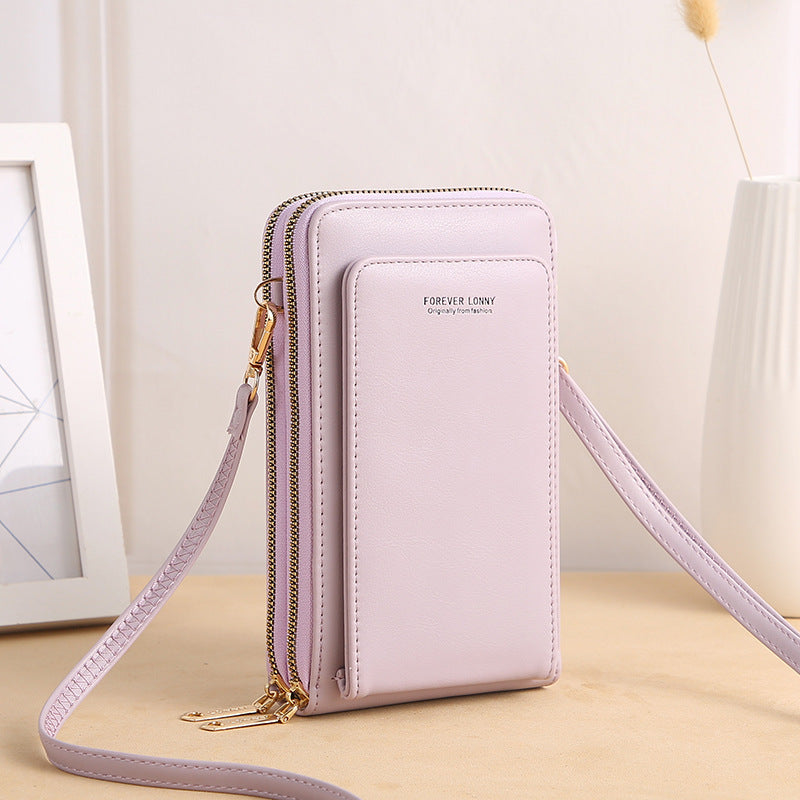 Light purple crossbody wallet purse with gold zippers on a neutral background, FashionRay style
