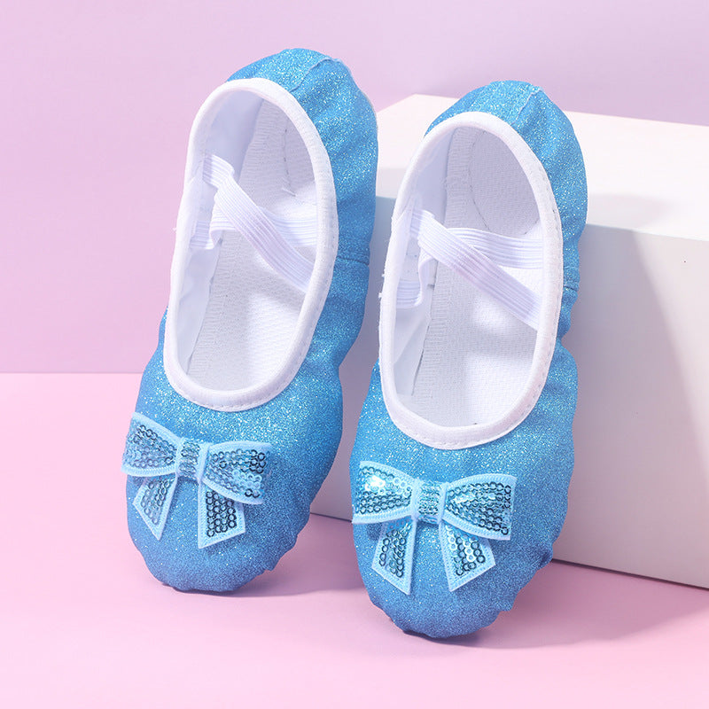 Sparkly blue ballet flats with sequin bows, children's shoes from FashionRay on pink background