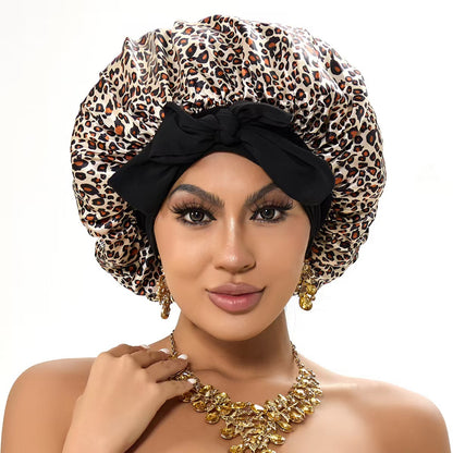 Woman in leopard print satin bonnet with black bow, gold jewelry, FashionRay style