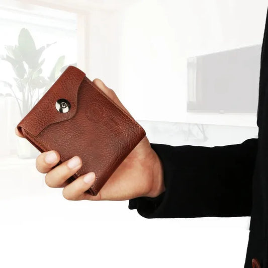 Hand holding a brown leather wallet in modern indoor setting, FashionRay style accessory