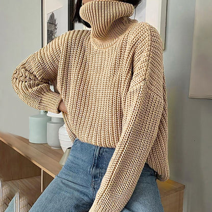Woman wearing chunky beige turtleneck sweater and blue jeans, cozy casual style by FashionRay