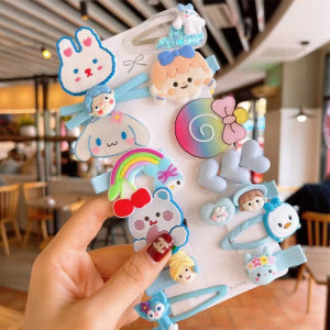 Cute pastel hair clips set with cartoon animal and rainbow designs, held in a stylish cafe