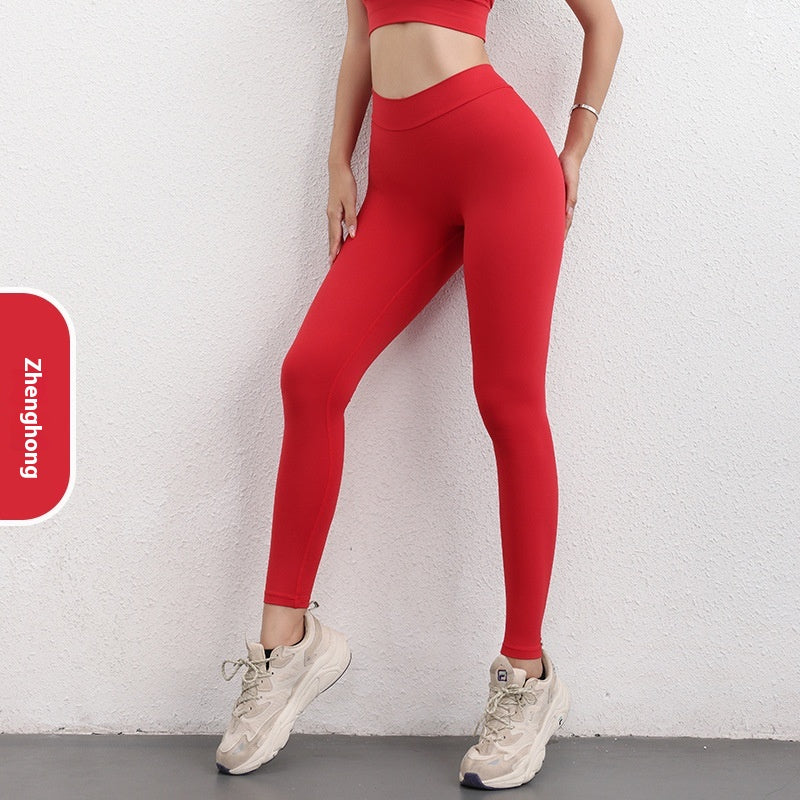 Woman wearing red seamless leggings and crop top, sporty fashion by FashionRay