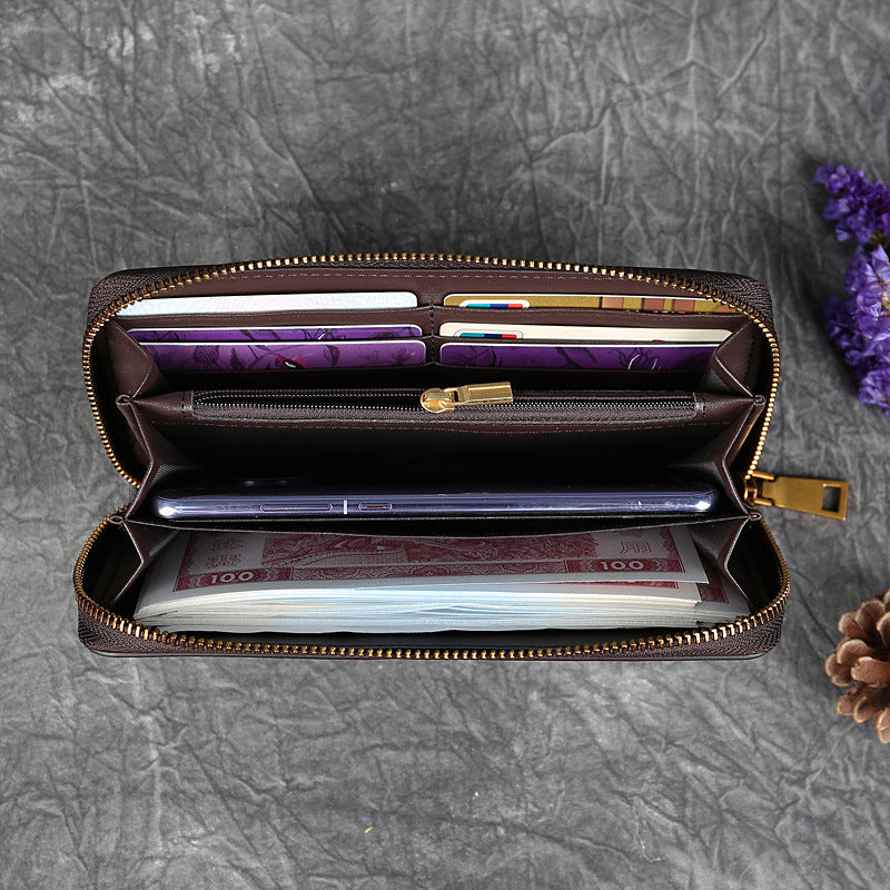 Brown zippered wallet with multiple card slots, cash compartments, and a phone inside.