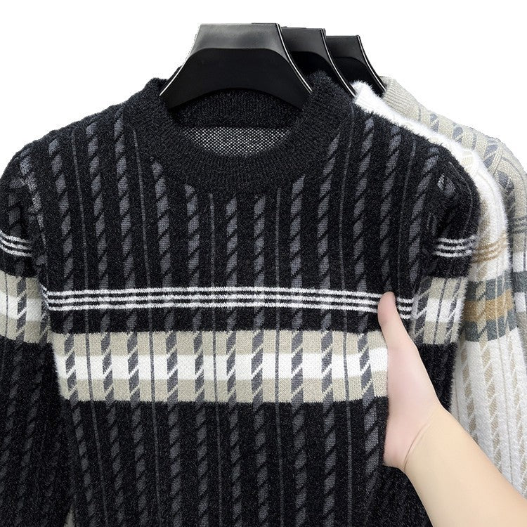 Hand holding a black and beige striped knit sweater on hanger, trendy FashionRay clothing