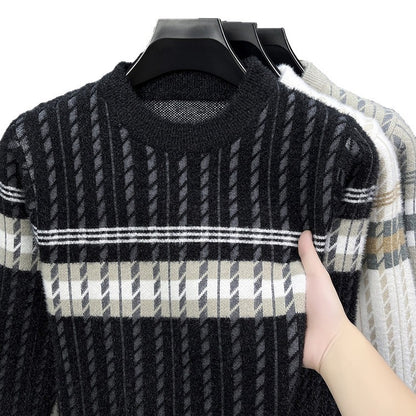 Hand holding a black and beige striped knit sweater on hanger, trendy FashionRay clothing