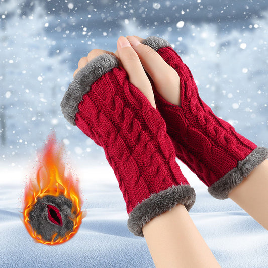 Red knit fingerless gloves with gray faux fur trim, worn outdoors in snowy winter setting.