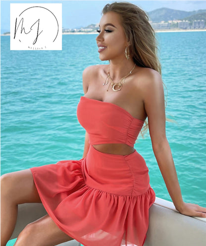 Woman in coral cutout dress by the sea, FashionRay trendy summer style, confident and chic
